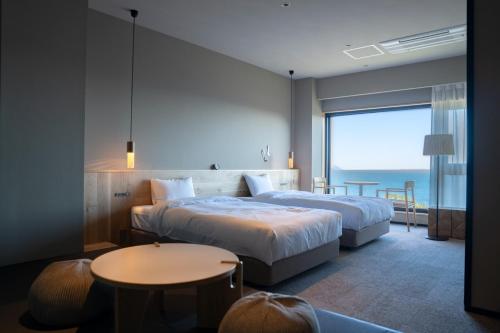 a hotel room with two beds and a table at HOTEL FARO manazuru - Vacation STAY 56470v in Manazuru