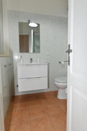 a bathroom with a white sink and a toilet at Casa Marconi in Acquapendente