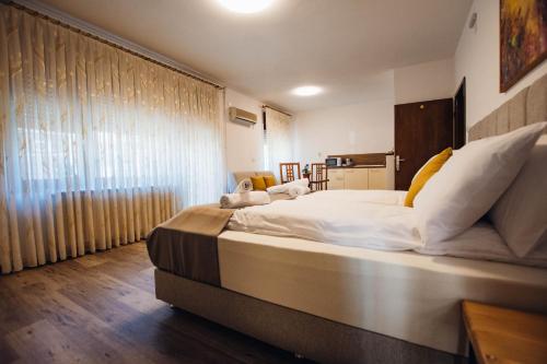 a large bed in a room with a large window at Urban Studio Apartments in Strumica