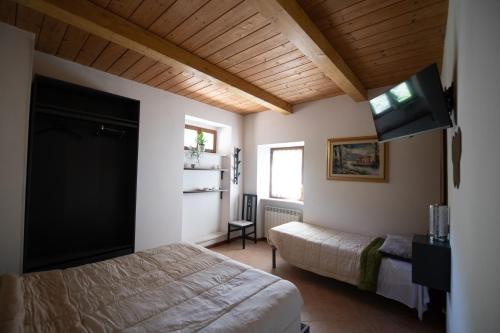 a bedroom with a bed and a flat screen tv at Affittacamere Casa Galiè in Comunanza
