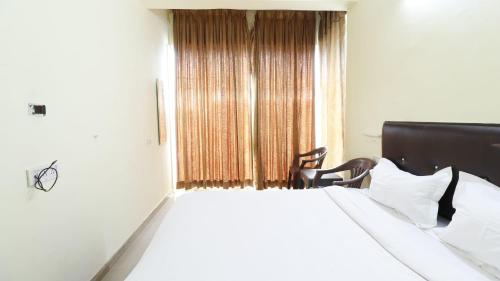 a bedroom with a large bed and a window at ROYAL PARK NEAR BELLANDHUR,HSR in Bangalore