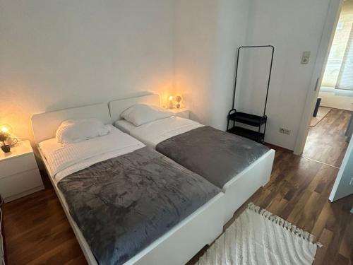 a large bed in a bedroom with two lights on at Stadtnahen Wohnung I Küche I Oelde in Oelde