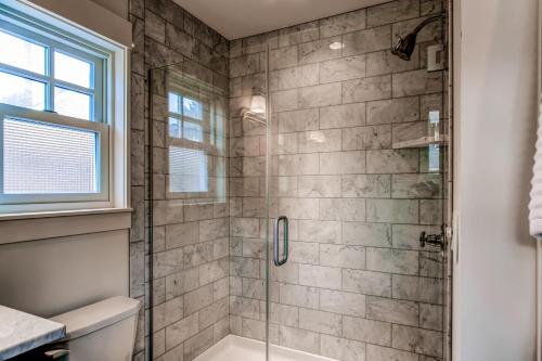 a bathroom with a shower with a glass door at Modern Gearhart Getaway, Walk to Beach and Downtown! in Gearhart