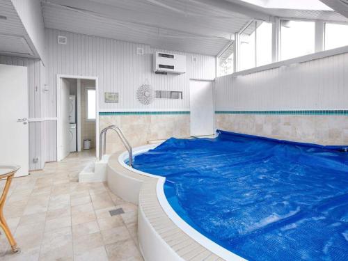 a large swimming pool in a room at Holiday home Ørsted V in Ørsted