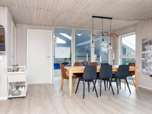 a dining room with a wooden table and chairs at 4 star holiday home in Ørsted-By Traum in Ørsted