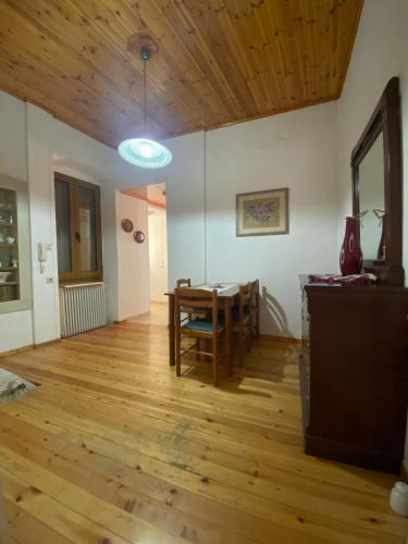 een woonkamer met een tafel en een houten vloer bij ΔΙΡΡΕΥΜΑΤΑ 