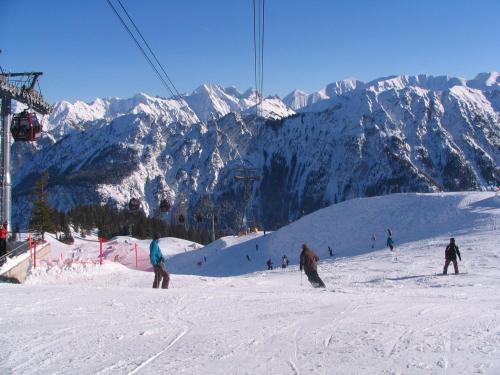a group of people skiing down a snow covered mountain at Alpengasthof Hotel Schwand in Oberstdorf