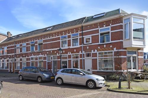 two cars parked in front of a brick building at Family house Scheveningen beach in Scheveningen