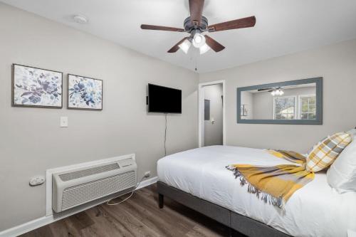 a bedroom with a bed and a ceiling fan at Downtown Kimmswick Studio Newly Renovated 