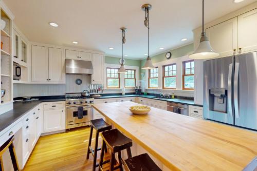 a large kitchen with a wooden table and chairs at Harbor Haven in Seattle