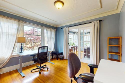 an office with a desk and chairs and windows at Harbor Haven in Seattle