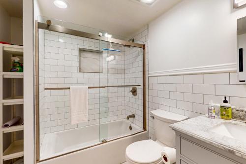 a bathroom with a shower and a toilet and a sink at Harbor Haven in Seattle
