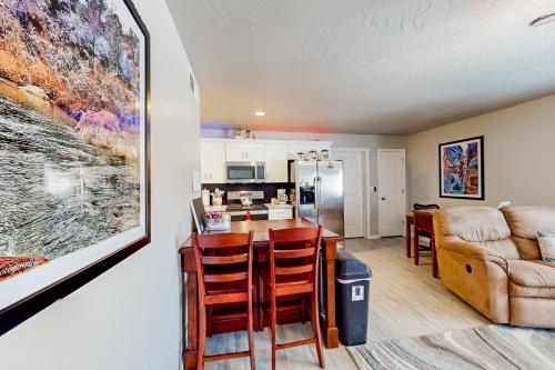 a kitchen and living room with a bar and a couch at Grandma's Southern Comfort Vacation Rental in Hurricane
