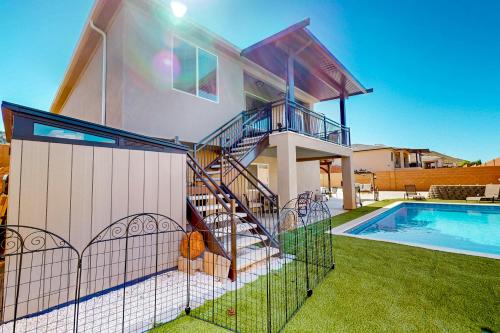 a house with a staircase next to a swimming pool at Grandma's Southern Comfort Vacation Rental in Hurricane