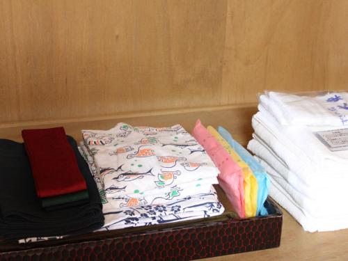 a box filled with towels and a pile of clothes at Izuito Onsen Daitokan in Ito