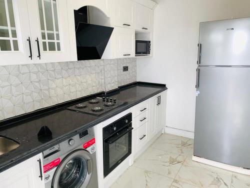 a kitchen with a refrigerator and a washer and dryer at Dakar Creek in Dakar