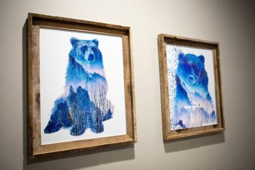 two paintings of a bear hanging on a wall at Downtown Whitefish awaits you at Central Ave Suite in Whitefish