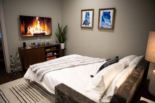 a bedroom with a bed and a tv on the wall at Downtown Whitefish awaits you at Central Ave Suite in Whitefish