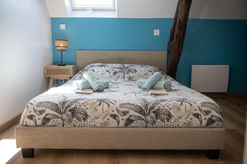 a bedroom with a bed with two pillows on it at La Belle Rive du voyageur in Bellerive-sur-Allier