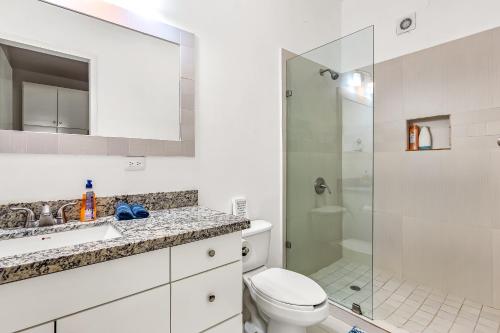 a bathroom with a shower and a toilet and a sink at Villa Querubines 53 - Playa Arcangel in Rosarito