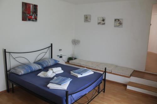 a bed with blue sheets and pillows in a room at Appartamenti Vacanza Il Riale in Cannobio