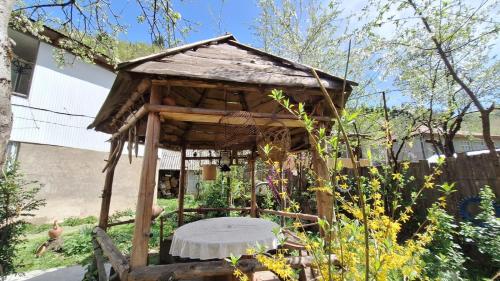 a wooden bird house in a garden at Guest House "SVANETI" in Lentekhi