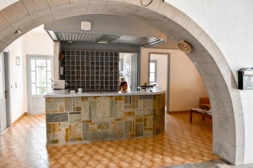 a kitchen with an archway in a house at Anamar Patmos in Skala