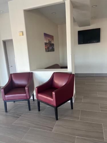 two chairs in a waiting room with a tv at Red Roof PLUS San Antonio Northeast in San Antonio