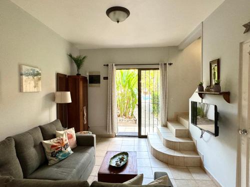 a living room with a couch and a tv at Pura Armonia Condo With Outdoor Patio in Coco