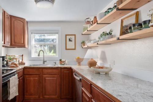 a kitchen with wooden cabinets and a counter top at Light Bright Stylish PRIVATE Home - Whitworth in Spokane
