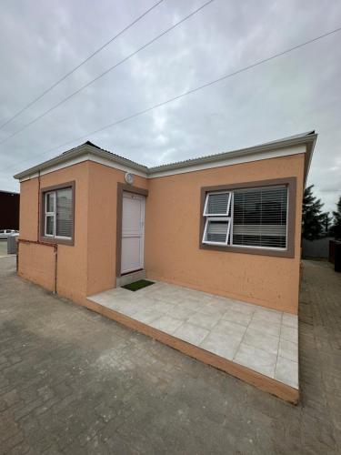 a small house with a driveway in front of it at Grandview adventure and guesthouse in East London