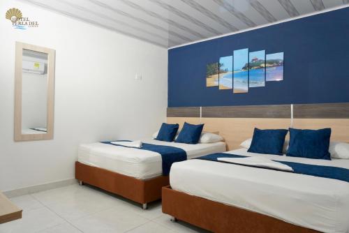 Postel nebo postele na pokoji v ubytování Hotel Perla del Caribe
