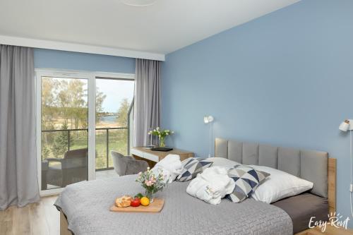 a bedroom with a bed with a tray of fruit on it at Sea View & SPA 10d10 in Dziwnów