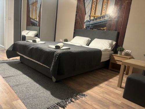 a bedroom with a bed with two towels on it at Downtown Parliament in Belgrade