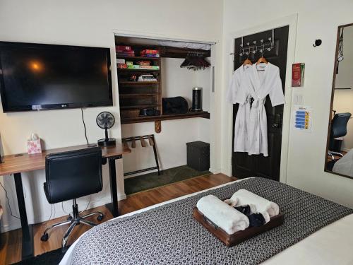 a bedroom with a bed with a robe hanging on the wall at Tranquility at the House of Alchemy Hollywood in Los Angeles