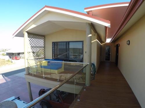 a balcony with a view of a house at On the Deck @ Shark Bay in Denham