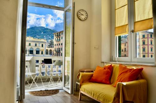 a living room with a couch and a clock on a window at La Torretta Boutique Accommodation in Rapallo