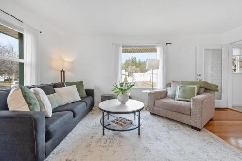 a living room with a couch and a chair and a table at Stylish & Bright 4BR - Close To Whitworth in Nine Mile Falls
