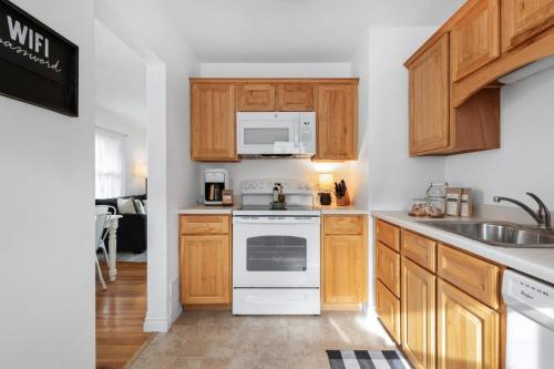 a kitchen with white appliances and wooden cabinets at Stylish & Bright 4BR - Close To Whitworth in Nine Mile Falls