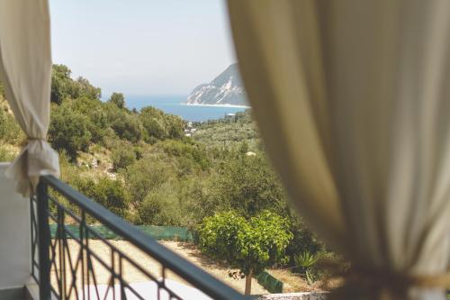 a view of the ocean from a balcony at Althea Studios Lefkada in Agios Nikitas