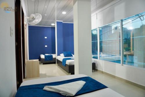 Postel nebo postele na pokoji v ubytování Hotel Perla del Caribe