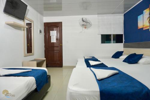 Postel nebo postele na pokoji v ubytování Hotel Perla del Caribe