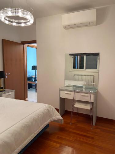 a bedroom with a bed and a desk and a window at Pool Apartment Bellagio in Bellagio
