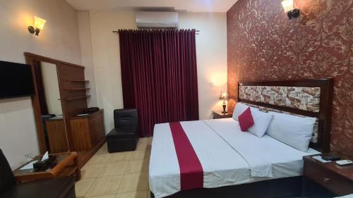 Ένα ή περισσότερα κρεβάτια σε δωμάτιο στο Executive Lodges