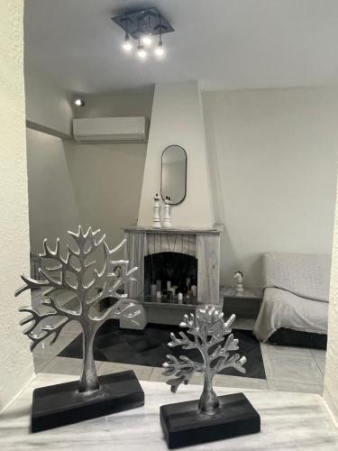 two metal trees in a living room with a fireplace at Summer Diamond in Kremasti