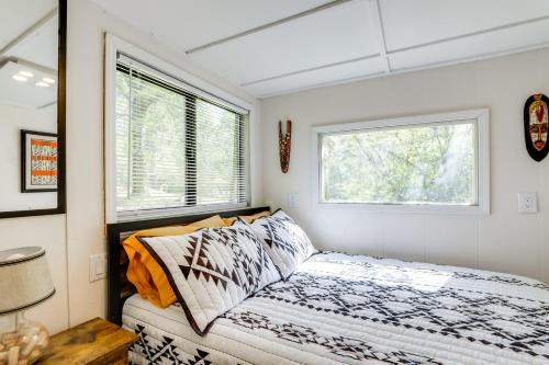 a bedroom with a bed and two windows at Georgia Tiny Home on Farm Retreat Hike On-Site! in Lithonia