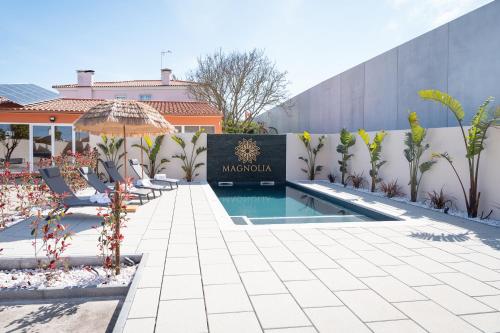 a resort with a pool and a sign that reads maserolis at Magnolia Luxury Villa in Vieira de Leiria