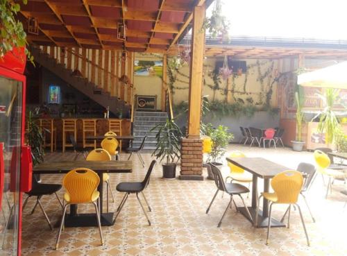 a patio with tables and chairs in a building at Ekshesh Hotel Bishoftu in Debre Zeyit