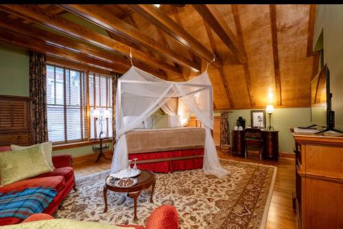 a bedroom with a canopy bed in a room at The Empress of Little Rock in Little Rock
