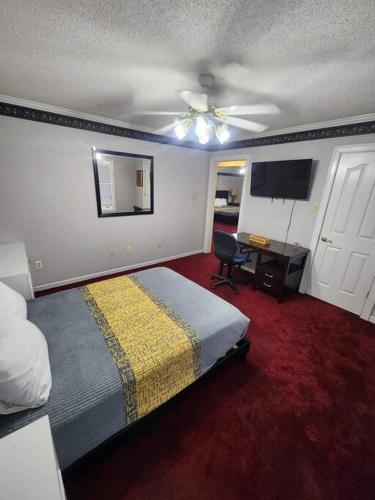 a bedroom with a bed and a ceiling fan at Southern Large Lake Front Custom Estate, Sleeps 16 in Olive Branch